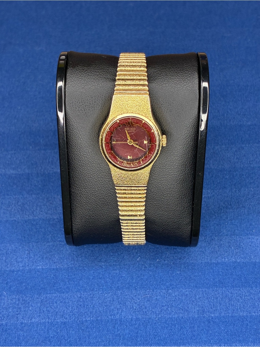 Vintage Seiko Galaxy Gold Tone Watch with Burgundy Dial and Textured Bracelet